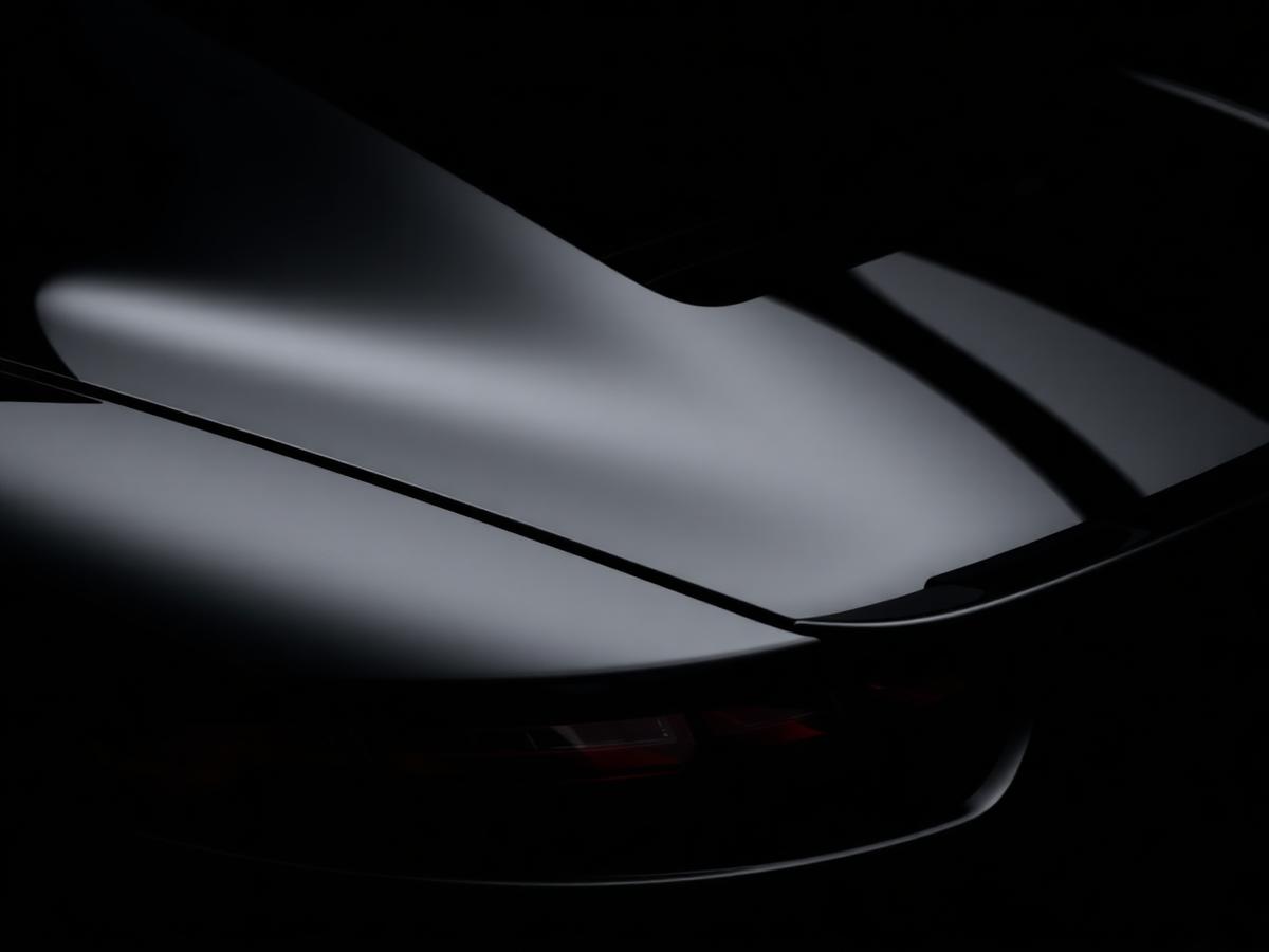 Glossy black sports car with mirror reflections